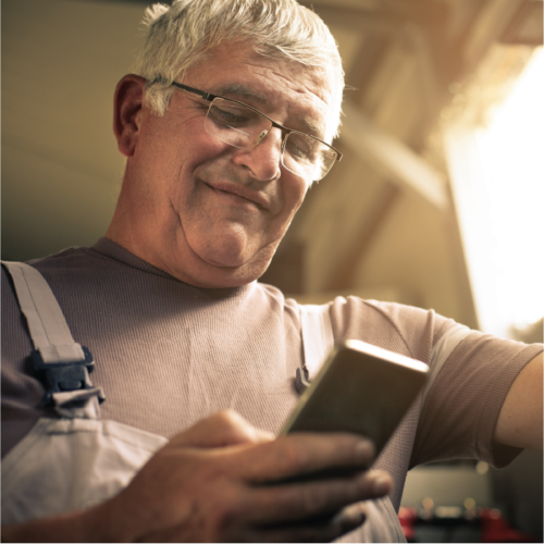 Smiling worker using his phone